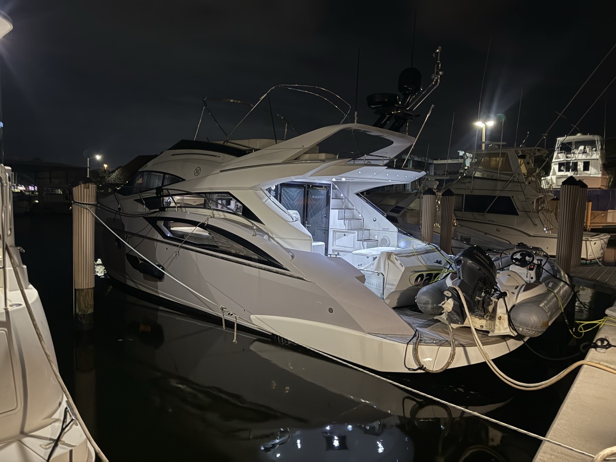 Princess Flybridge yacht illuminated at night in the marina